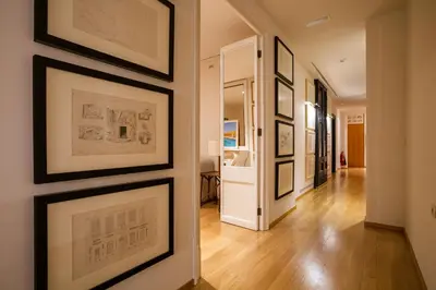 a hallway with framed pictures on a wall at Hotel Margot House Barcelona in Barcelona