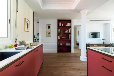 a kitchen with red cabinets and a white column at Rental Apartment Barcelona in Barcelona