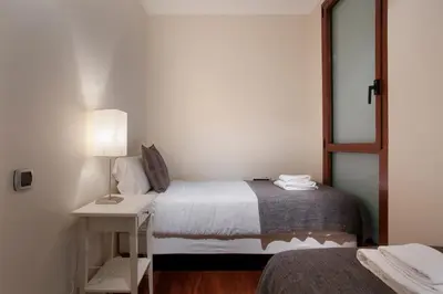 a bedroom with a bed and a table with a lamp at Tendency Rambla Catalunya in Barcelona
