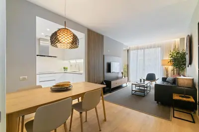 a kitchen and living room with a table and chairs at Tendency Rambla Catalunya in Barcelona