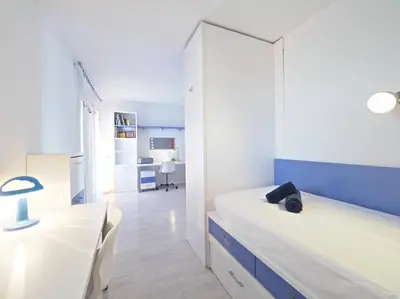 a bedroom with a bed and a dining room at BCN | Duplex Penthouse & Pool in Sant Andreu de Llavaneres