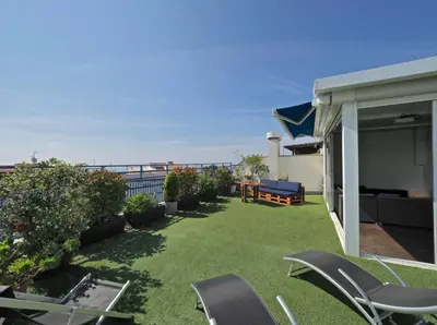 a yard with chairs and a patio with the ocean at BCN | Duplex Penthouse & Pool in Sant Andreu de Llavaneres