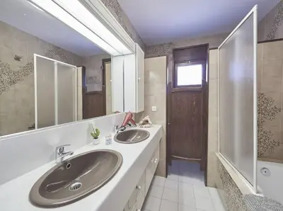 a bathroom with two sinks and a shower at Villa Julia | 14pax. 5' sea & train in Sant Andreu de Llavaneres