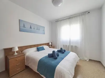 a bedroom with a bed with blue pillows on it at Villa Julia | 14pax. 5' sea & train in Sant Andreu de Llavaneres