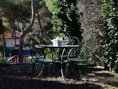 a table and chairs sitting in a yard at Vacarisses- Torreblanca Estacin in Vacarisas