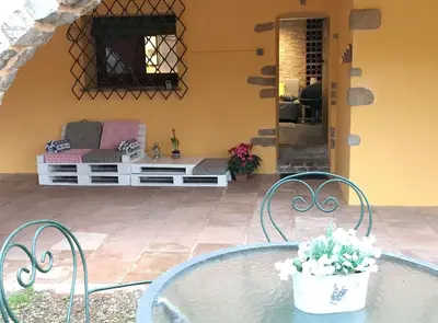 a patio with a glass table and chairs at Vacarisses- Torreblanca Estacin in Vacarisas
