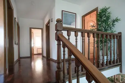 a staircase in a home with a wooden stair case at Elis house Piscina Privada Villa Mediterránea in Castelldefels