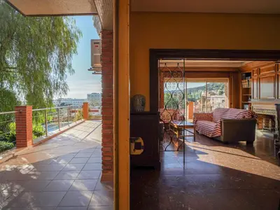 a living room with a couch and a balcony at Bed BCN Hills House in Barcelona
