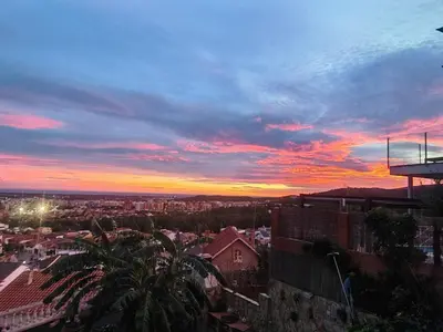 a view of a city at sunset at Apartamento con vistas al mar in Viladecáns