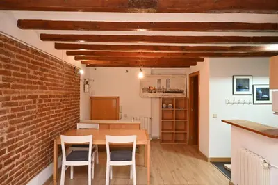 a dining room with a brick wall and a table and chairs at Homenfun Barcelona Poblenou in Barcelona