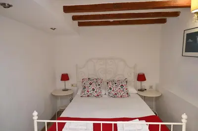 a bedroom with a white bed with two tables at Homenfun Barcelona Poblenou in Barcelona
