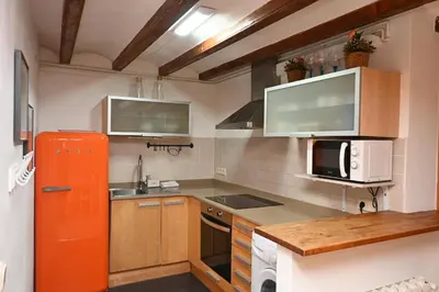 a kitchen with an orange refrigerator and a microwave at Homenfun Barcelona Poblenou in Barcelona