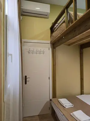 a room with a closet and a door and a bed at Casa Acogedora in Hospitalet de Llobregat