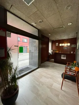 a lobby with a large glass door in a building at Hotel Sant Celoni in San Celoni