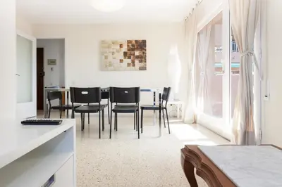 a kitchen and dining room with black chairs and a table at Pubone AT Sabadell in Sabadell