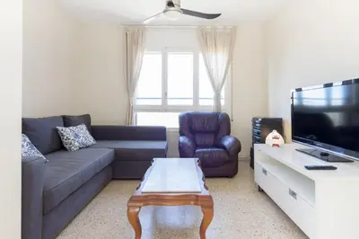 a living room with a couch and a tv at Pubone AT Sabadell in Sabadell