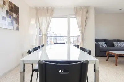 a dining room with a white table and chairs at Pubone AT Sabadell in Sabadell