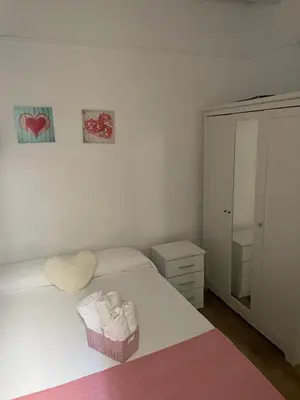a bedroom with a bed with a dresser and a mirror at Alojamiento muy cómodo in Hospitalet de Llobregat
