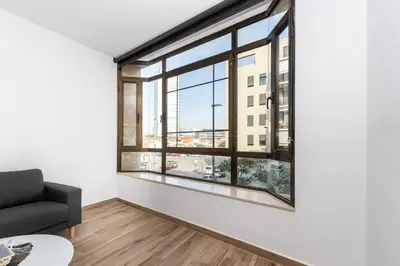 an empty living room with a large window at Macu in Sabadell