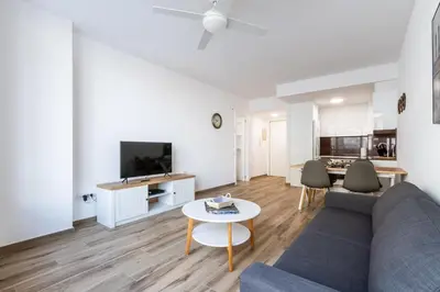 a living room with a couch and a table at Macu in Sabadell