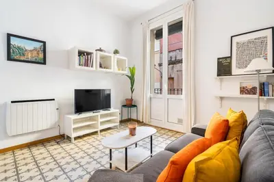 a living room with a couch and a tv at Progres in Barcelona