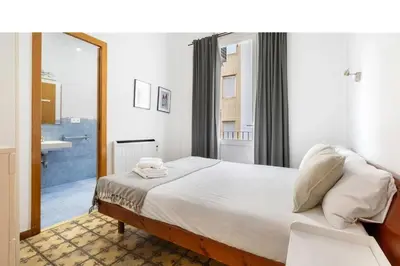 a bedroom with a large bed and a mirror at Progres in Barcelona