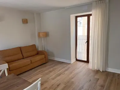 a living room with a couch and a table at The Nest Masia Can Tiranasi Relájate y Disfruta Escapada con Encanto Cerca de Barcelona- in Badalona
