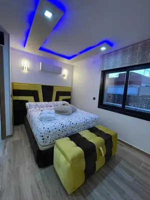 a bedroom with a bed and a blue ceiling at A comfortable apartment in Santa Coloma de Gramanet