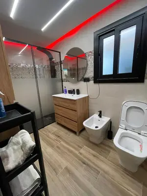 a bathroom with a toilet and a sink and a mirror at A comfortable apartment in Santa Coloma de Gramanet