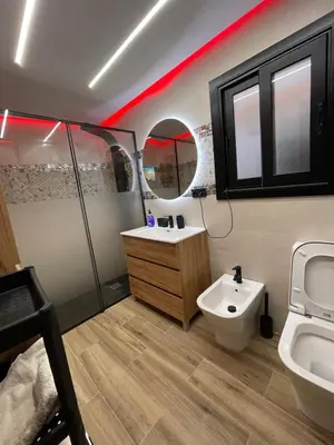 a bathroom with a sink and a toilet and a mirror at A comfortable apartment in Santa Coloma de Gramanet