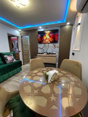 a living room with a table and a couch at A comfortable apartment in Santa Coloma de Gramanet