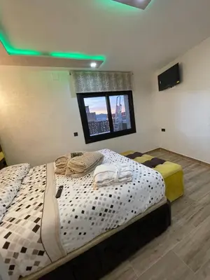 two twin beds in a room with a window at A comfortable apartment in Santa Coloma de Gramanet