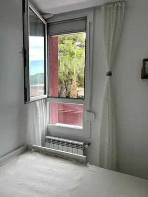 a bedroom with a bed and a window at Beach apartment 2 terraces with parking in Castelldefels