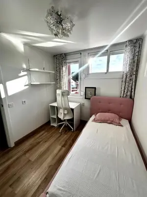 a bedroom with a bed and a desk and a chair at Beach apartment 2 terraces with parking in Castelldefels