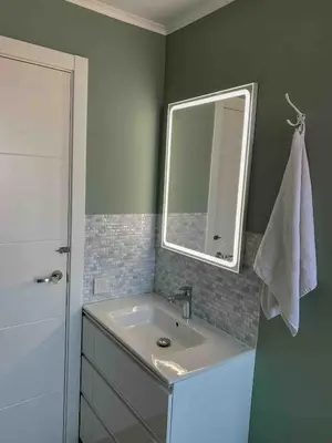 a bathroom with a sink and a mirror at Beach apartment 2 terraces with parking in Castelldefels