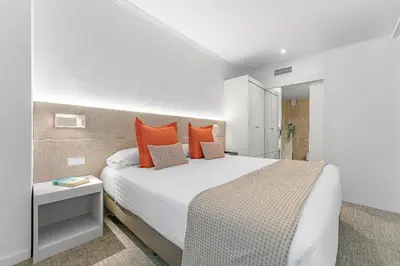 a living room with a couch and a kitchen at Acacia Suite in Barcelona
