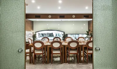 a dining room with a wooden table and chairs at Acacia Suite in Barcelona