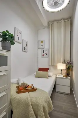 a bedroom with two beds and a tray of food on a bed at BBarcelona Gracia Apartment in Barcelona