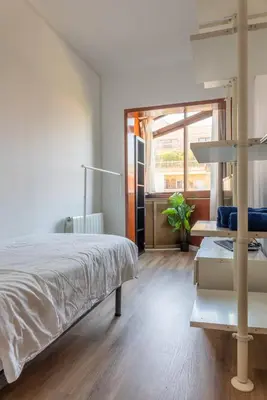 a bedroom with a large bed and a window at Sagrada Familia views, big and bright apartment in Barcelona