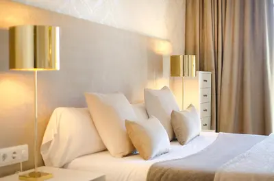 a bedroom with a white bed with four pillows at Three bedroom apartment in Gran de Gracia - You Stylish Apartments in Barcelona