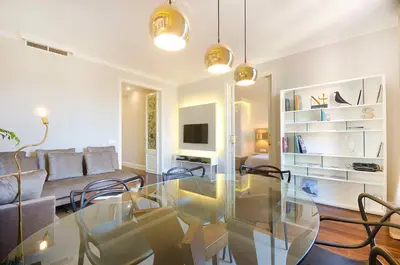 a living room with a glass table and chairs at Three bedroom apartment in Gran de Gracia - You Stylish Apartments in Barcelona