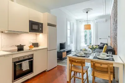 a living room with a couch and a brick wall at 4305 - AB Eixample Sepúlveda 157 in Barcelona