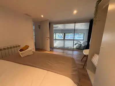 a bedroom with a bed and a large window at Apartment close Barcelona - Rentals Badalona Beach - Free Parking in Badalona