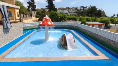 a small pool with a mushroom water slide at Camping Victoria in Canet de Mar