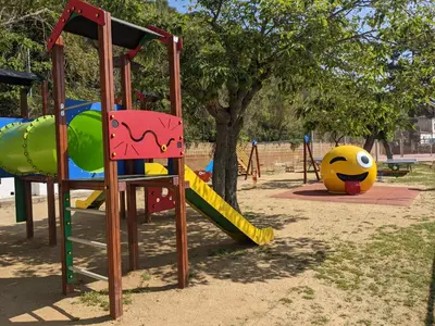 a playground with a slide in a park at Camping Victoria in Canet de Mar