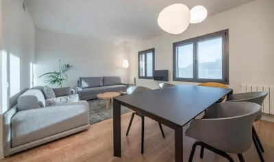 a living room with a table and chairs at Central One bedroom apartment You Stylish Apartments in Barcelona