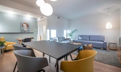a living room with a table and chairs at Central One bedroom apartment You Stylish Apartments in Barcelona