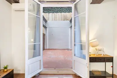 an open door leading into a room with a hallway at Muntaner in Barcelona