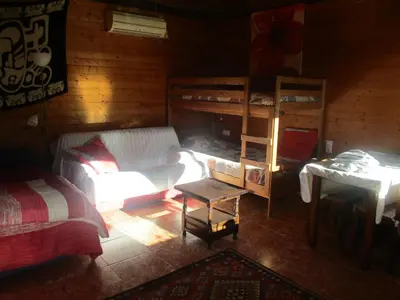 a living room with a bed and bunk beds at Climbers Cabin in Marganell