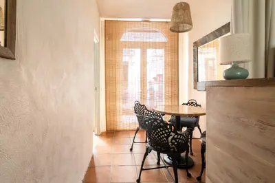 a room with a table and chairs and a window at Rainbow Sitges in Sitges